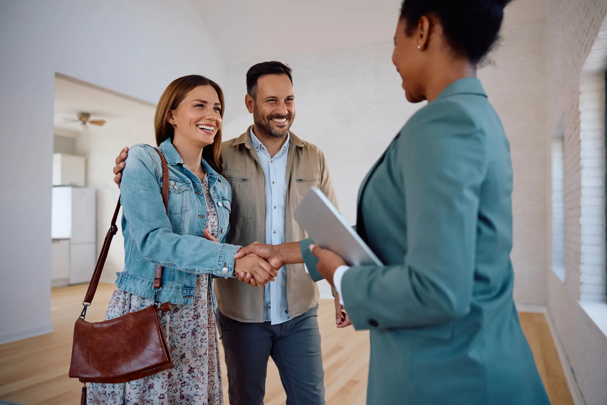 Couple meeting with real estate agent indoors.