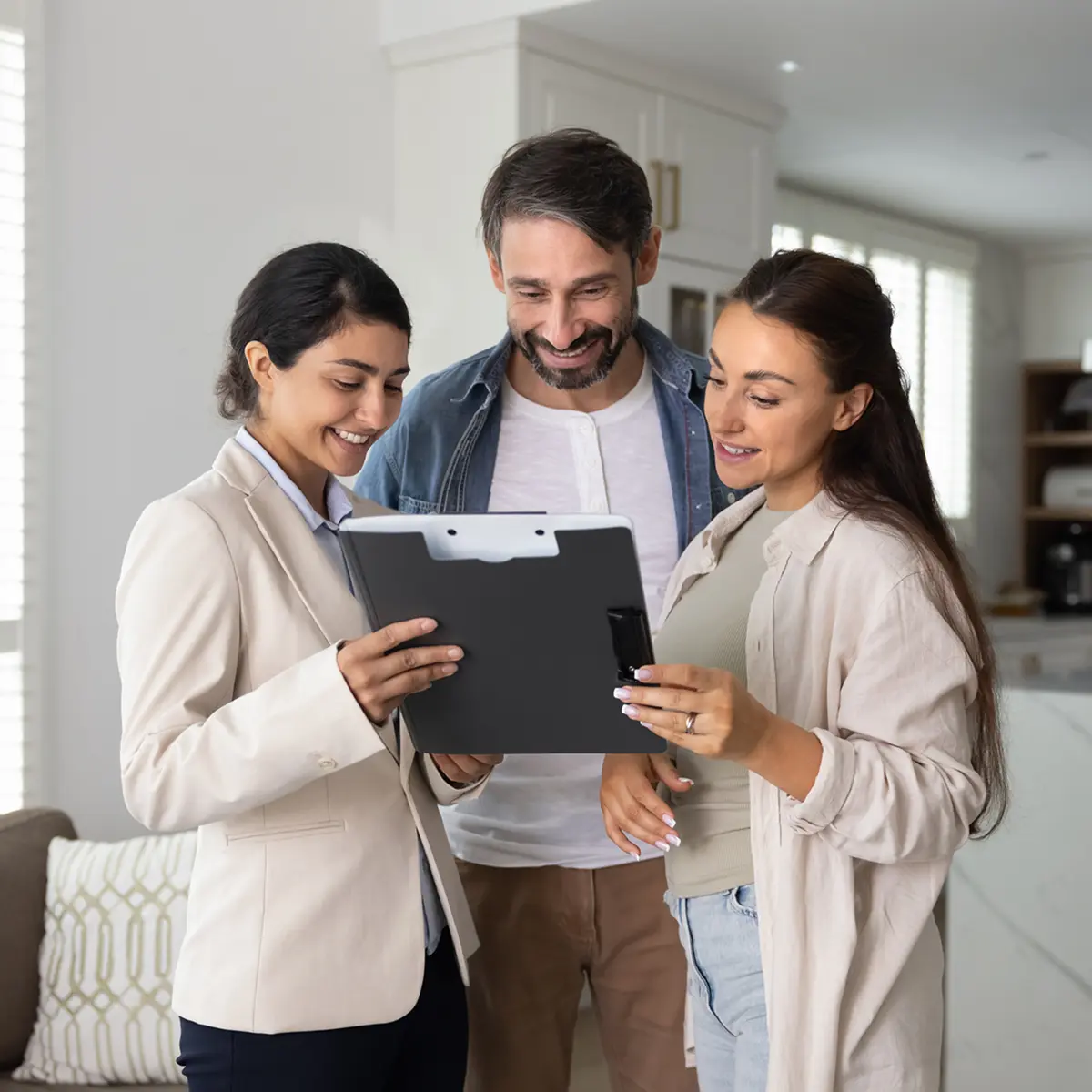 Three people discussing with a tablet.
